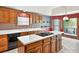 Kitchen with light countertops, wood cabinets, and island cooktop at 3185 Country Club Nw Ct, Kennesaw, GA 30144