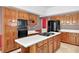 Kitchen with light countertops, wood cabinets, and island cooktop at 3185 Country Club Nw Ct, Kennesaw, GA 30144