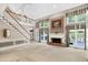Open living room featuring a brick fireplace and staircase at 3185 Country Club Nw Ct, Kennesaw, GA 30144