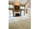 Spacious living room with a fireplace, built-in shelving, and natural light at 3185 Country Club Nw Ct, Kennesaw, GA 30144
