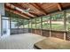 Enclosed porch with vaulted wood ceiling, fan, and screens offering natural light and outdoor views at 3185 Country Club Nw Ct, Kennesaw, GA 30144