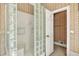 Shower featuring glass block surround and built-in shelves at 3185 Country Club Nw Ct, Kennesaw, GA 30144