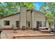 This backyard has a patio with outdoor seating, a classic design, and mature trees at 3902 Cedarwoods Way, Lawrenceville, GA 30044