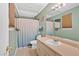 Bathroom featuring a vanity with a sink, a large mirror, and a shower with curtain at 3902 Cedarwoods Way, Lawrenceville, GA 30044