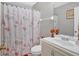 This bathroom features a vanity with a sink, a framed mirror, and a Paris-themed shower curtain at 3902 Cedarwoods Way, Lawrenceville, GA 30044