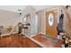 Welcoming foyer featuring hardwood floors, a stylish front door with glass insert, and a bar with seating at 3902 Cedarwoods Way, Lawrenceville, GA 30044