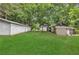Expansive backyard featuring outbuildings and mature trees creating a private oasis at 3961 Jodeco Rd, Mcdonough, GA 30253