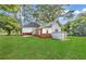 Expansive backyard with lush green grass, brick foundation and detached garage at 3961 Jodeco Rd, Mcdonough, GA 30253