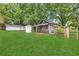Backyard featuring well maintained green lawn and assorted exterior outbuildings at 3961 Jodeco Rd, Mcdonough, GA 30253