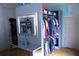 Well-organized walk-in closet with clothing storage and a vanity featuring a mirror at 3961 Jodeco Rd, Mcdonough, GA 30253
