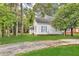 Quaint house featuring light gray siding, blue shutters, and lush green surroundings at 3961 Jodeco Rd, Mcdonough, GA 30253