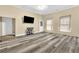 Spacious living room with modern gray vinyl floors, neutral walls, and a large mounted television at 3961 Jodeco Rd, Mcdonough, GA 30253