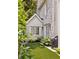 The backyard features artificial turf, a whitewashed brick wall, and a partial view of the home's exterior at 54 Camden Ne Rd, Atlanta, GA 30309