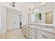 Well-lit bathroom with double vanity, granite counters, and a large mirror at 54 Camden Ne Rd, Atlanta, GA 30309