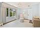 Light and airy Bedroom with a chair, patterned ottoman, and hardwood floors at 54 Camden Ne Rd, Atlanta, GA 30309