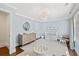 Inviting Bedroom with a crib, dresser with changing table, and soft blue walls at 54 Camden Ne Rd, Atlanta, GA 30309