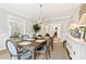 Dining room featuring a long wooden table with decor, six chairs, and a white sideboard at 54 Camden Ne Rd, Atlanta, GA 30309