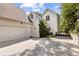 Home's exterior features a spacious garage, driveway and a manicured lawn that is surrounded by mature trees at 54 Camden Ne Rd, Atlanta, GA 30309