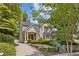 Charming stone home with manicured front yard, columns, and inviting entryway at 54 Camden Ne Rd, Atlanta, GA 30309