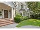 Elegant brick home showcasing detailed trim, a bay window, and lush landscaping at 54 Camden Ne Rd, Atlanta, GA 30309