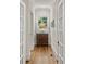 Hallway with hardwood floors, classic moulding, and a decorative wood cabinet at 54 Camden Ne Rd, Atlanta, GA 30309