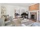 Cozy living room with exposed brick fireplace, piano, and stylish furnishings at 54 Camden Ne Rd, Atlanta, GA 30309