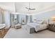 Serene main bedroom with tray ceiling, neutral tones, sitting area, and ample natural light at 54 Camden Ne Rd, Atlanta, GA 30309