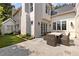 Inviting stone patio features an outdoor dining set and manicured lawn perfect for relaxation and entertaining guests at 54 Camden Ne Rd, Atlanta, GA 30309