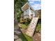 Backyard playhouse with climbing wall, accessed by stone stairs and surrounded by lush foliage, for outdoor fun at 54 Camden Ne Rd, Atlanta, GA 30309