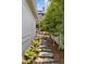 Beautiful landscaped side yard with stone pathway, lush greenery, and a peaceful ambiance enhances the property's appeal at 54 Camden Ne Rd, Atlanta, GA 30309