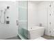 Bathroom featuring a walk in shower and freestanding tub at 788 W Marietta St # 1809, Atlanta, GA 30318