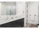 Bathroom featuring double vanity, a large mirror, and a walk in shower at 788 W Marietta St # 1809, Atlanta, GA 30318