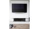 Contemporary fireplace with a sleek design, mounted beneath a large flat screen TV at 788 W Marietta St # 1809, Atlanta, GA 30318
