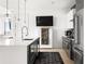 Modern kitchen with stainless steel appliances, white countertops, a bar area and hardwood floors at 788 W Marietta St # 1809, Atlanta, GA 30318
