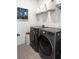 Efficient laundry room featuring modern washer and dryer units, overhead shelving, and stylish decor at 788 W Marietta St # 1809, Atlanta, GA 30318