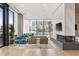 Bright living room featuring large windows, hardwood floors, modern fireplace, and stylish furniture at 788 W Marietta St # 1809, Atlanta, GA 30318
