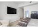 Contemporary bedroom featuring a TV, modern furnishings and light hardwood floors at 788 W Marietta St # 1809, Atlanta, GA 30318