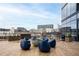 Modern rooftop patio featuring an outdoor fireplace, comfortable seating, and city views at 788 W Marietta St # 1809, Atlanta, GA 30318