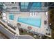 Aerial view of a community pool and hot tub surrounded by seating and lush landscaping at 788 W Marietta St # 1809, Atlanta, GA 30318