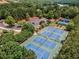 Aerial view of community tennis courts surrounded by lush greenery and mature trees at 1045 Pine Bark Ln, Canton, GA 30114