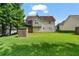 A spacious backyard with lush grass, shed, and a view of the home's deck and upper level at 335 Lee Miller Ct, Suwanee, GA 30024