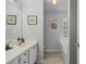 Clean bathroom with single vanity, large mirror, and tile floors at 335 Lee Miller Ct, Suwanee, GA 30024