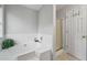 Bathroom featuring tiled tub, enclosed shower, and white cabinets at 335 Lee Miller Ct, Suwanee, GA 30024