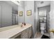 Well-lit bathroom with a large mirror, neutral-toned walls, and a classic vanity at 335 Lee Miller Ct, Suwanee, GA 30024