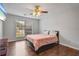 Bedroom with a ceiling fan, large window, and hardwood floors at 335 Lee Miller Ct, Suwanee, GA 30024