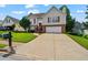 Charming two-story home with brick accents, red shutters, and a well-manicured lawn and driveway at 335 Lee Miller Ct, Suwanee, GA 30024