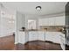 Bright kitchen with white cabinets, stainless appliances, and hardwood floors at 335 Lee Miller Ct, Suwanee, GA 30024