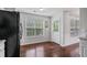 Eat in kitchen featuring hardwood floors, large windows, and stainless steel appliances at 335 Lee Miller Ct, Suwanee, GA 30024