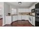 Clean kitchen with white cabinets, updated appliances, and granite countertops at 335 Lee Miller Ct, Suwanee, GA 30024