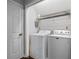 Efficient laundry room featuring a modern washer and dryer set, as well as convenient overhead shelving at 335 Lee Miller Ct, Suwanee, GA 30024